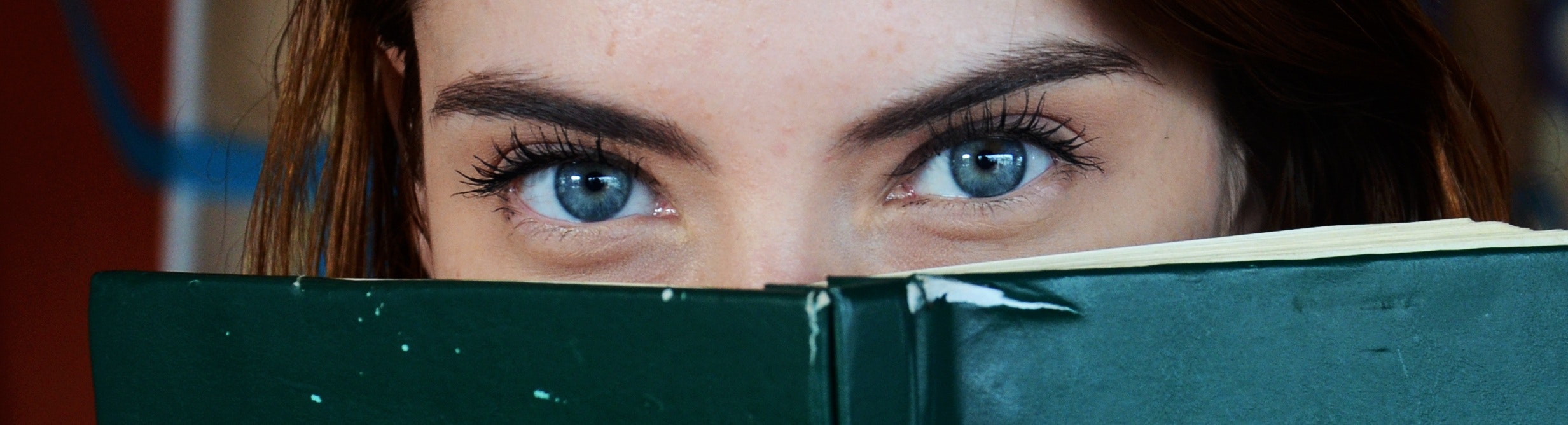woman with blue eyes reading