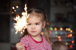 kid holding sparkler