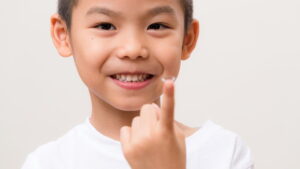 boy holding contact lense