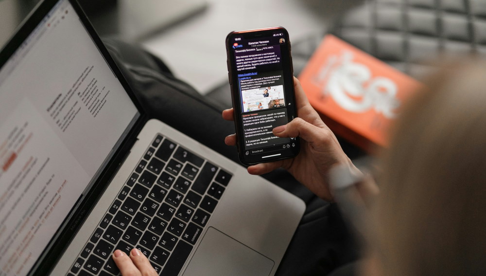 person using phone and computer