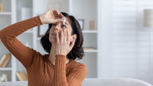 pouring eyedrops into eye