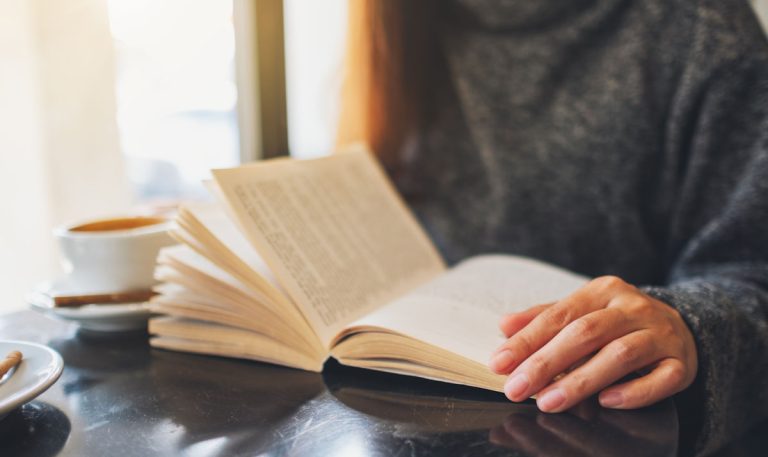 reading a book on a table