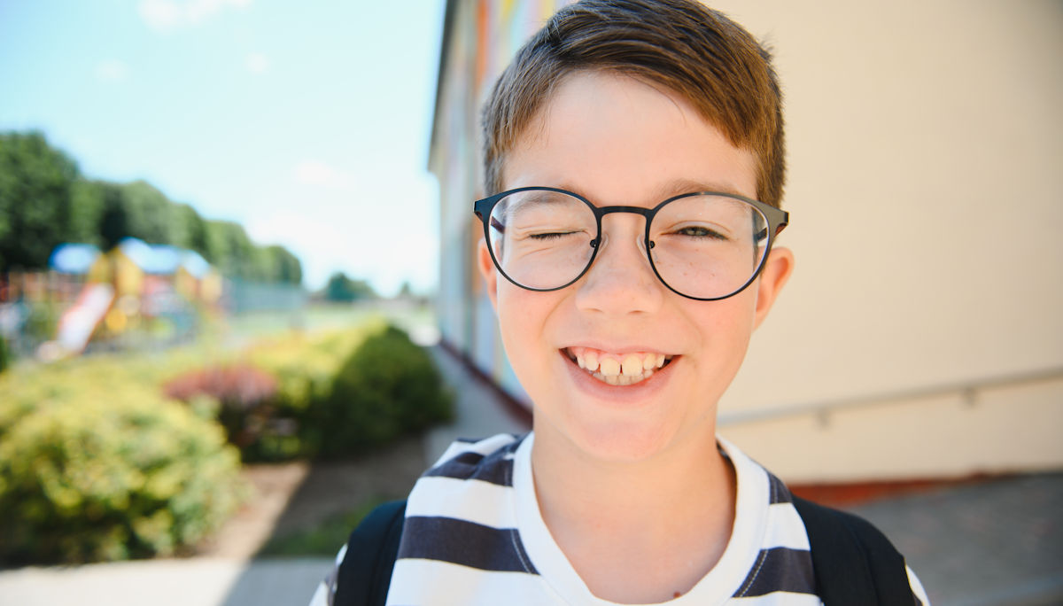 smiling kid in glasses
