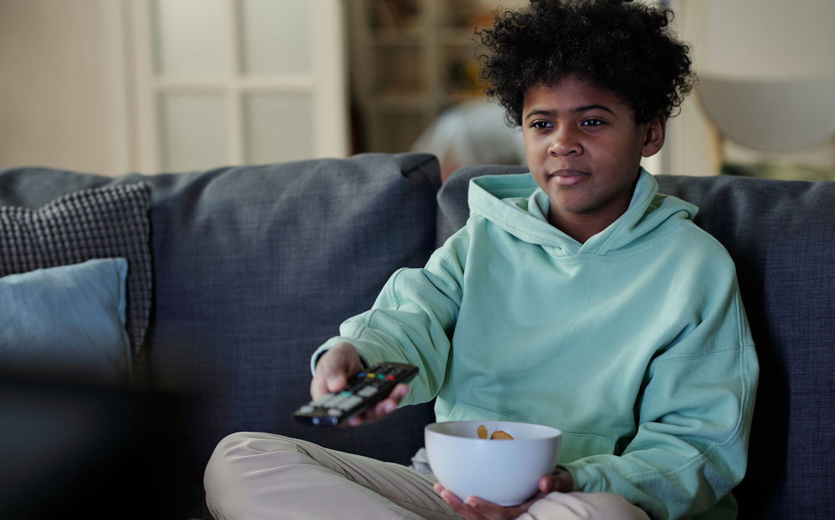 boy watching TV with snack
