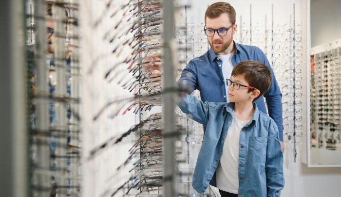 dad and son picking out eyewear